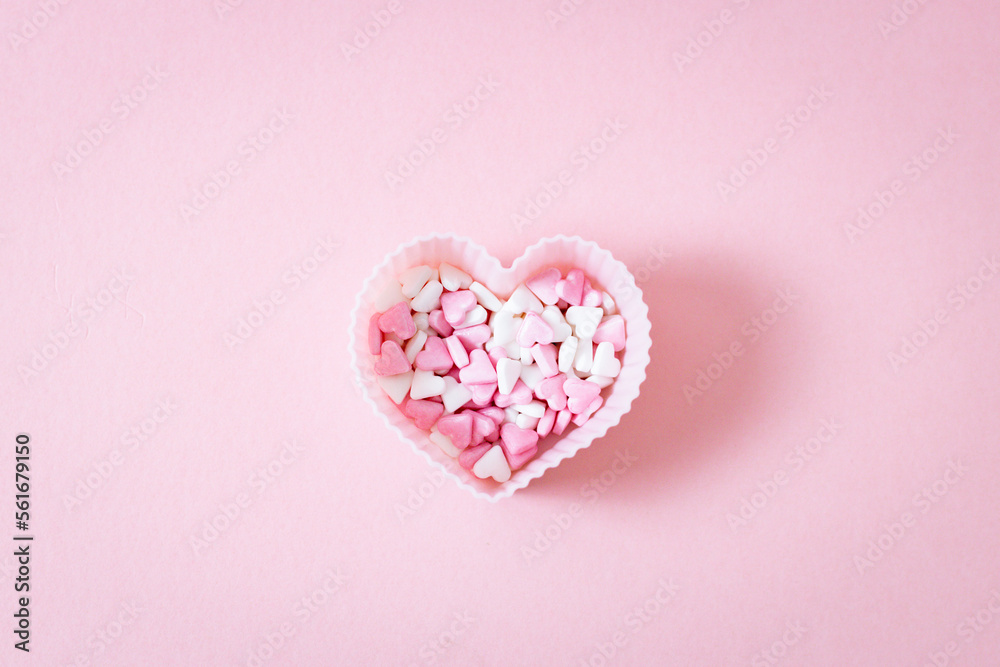 One form for a muffin heart with candy sprinkles on a pink background.