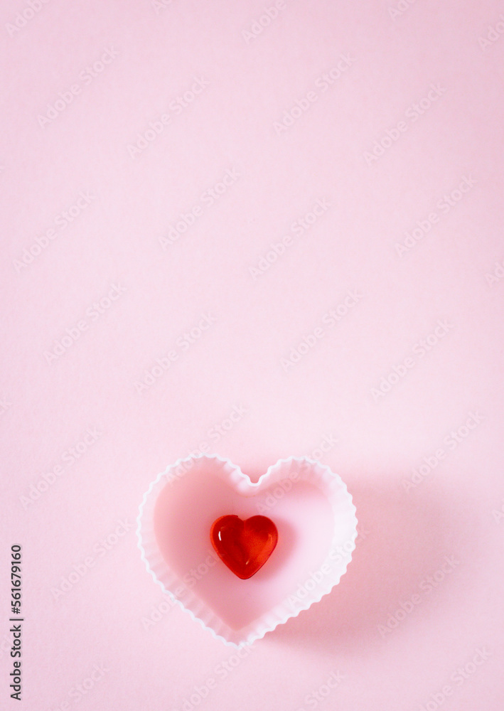 One muffin shape with a red heart on a pink background.