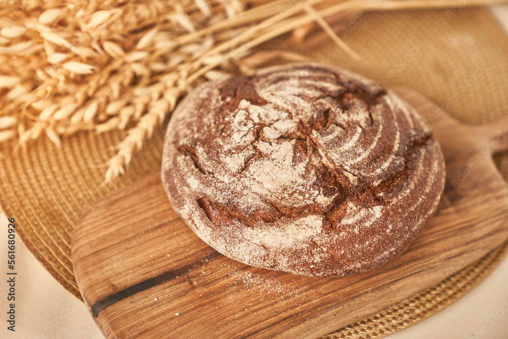 Whole grain bread on a wooden kitchen plate. Fresh bread on the table close-up. Fresh bread on the kitchen table. The concept of healthy eating and traditional bakery. High quality photo Whole grain bread on a wooden kitchen plate. Fresh bread on the table close-up. Fresh bread on the kitchen table. The concept of healthy eating and traditional bakery. High quality photo