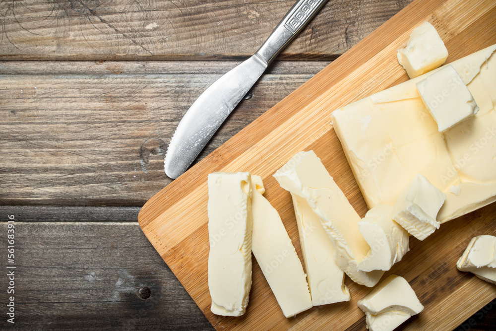 Butter with a knife on the Board.