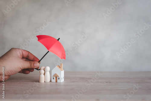 Umbrella cover house and family for protect your house and property including health care. Health insurance or life insurance business and health care and real estate concept.