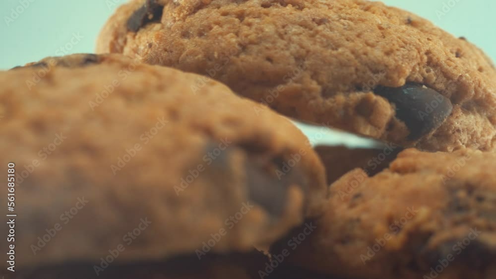 A macro close up shot of a white plate full of delicious chocolate chip cookies, on a 360 rotating stand, studio lighting, slow motion, 4K video. A macro close up shot of a white plate full of delicious chocolate chip cookies, on a 360 rotating stand, studio lighting, slow motion, 4K video.