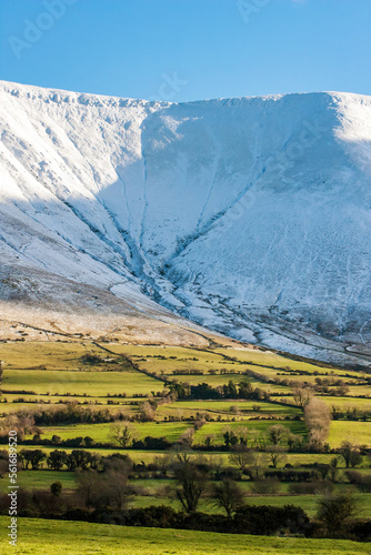 Snowy Mountains and Green fields in Ireland photo