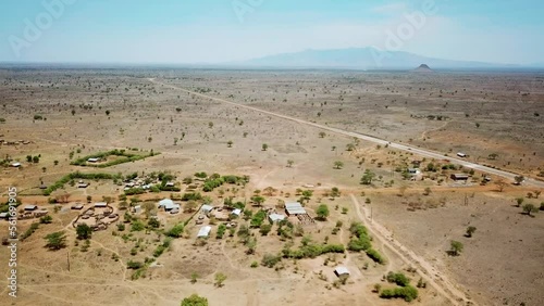 Aerial view zooming out from a village of Karamoja, also known as Manyatta or Ere, on a sunny day in Uganda, Africa. High quality 4k footage photo