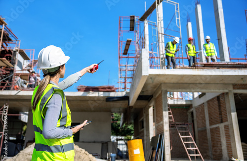The engineer talks to the contractor to supervise and plan the work.
