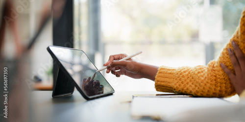 Young black curly hair American African woman using digital tablet photo