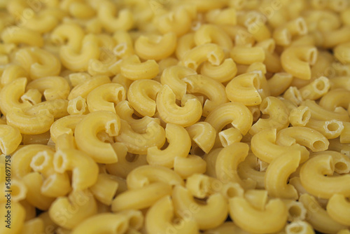 background and texture of pile of raw macaroni