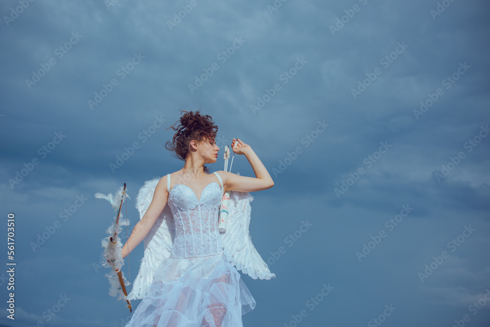 Cute teen cupid, valentine day with bow arrow shooting. Teenager angel with angels wings.