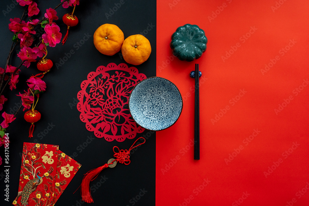 Chinese lunar new year decoration over red and black background. Flat lay dinning table concept with festive decoration. Translation for word on decoration mean “blessing” and Chinese lunar new year decoration over red and black background. Flat lay dinning table concept with festive decoration. Translation for word on decoration mean “blessing” and