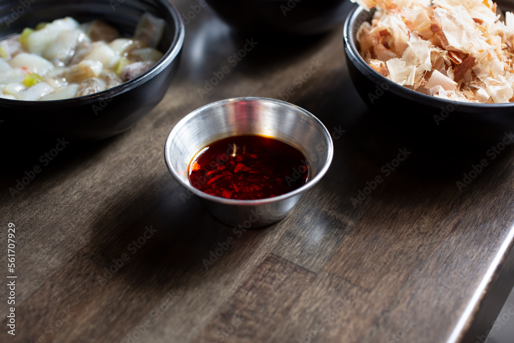 A view of a condiment cup of chili oil. A view of a condiment cup of chili oil.