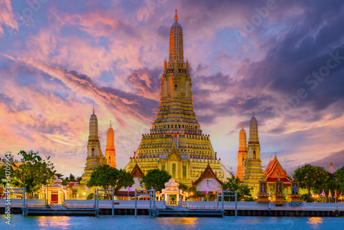Wat Arun temple Bangkok during sunset in Thailand. Chao praya river