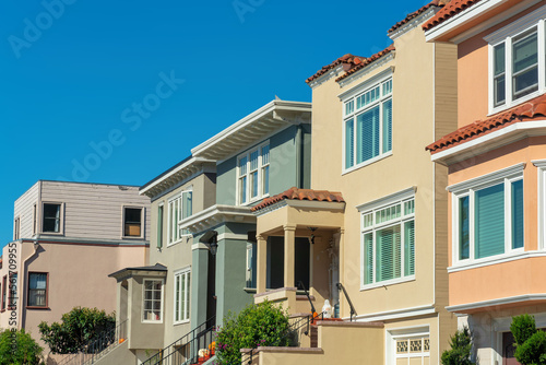 Row of decorative and colorful house facades or exteriors on homes in historic district of san francisco california