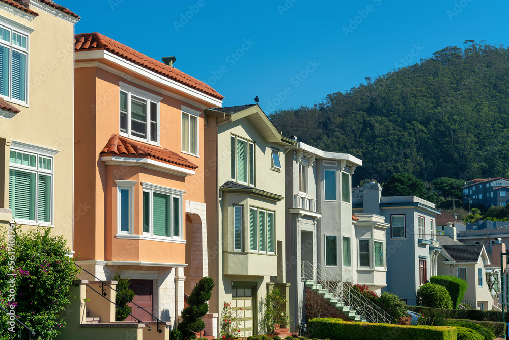 Row of decorative house facades or exteriors in historic districts of san francisco california in late afternoon sun