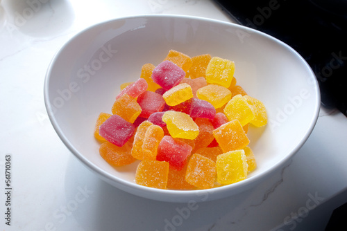 A view of a bowl of sour gummy candy.