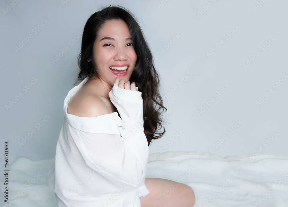Asian happy beautiful woman wearing white shirt raise hand touching on chin with smiling. Mental wellness. Asian happy beautiful woman wearing white shirt raise hand touching on chin with smiling. Mental wellness.