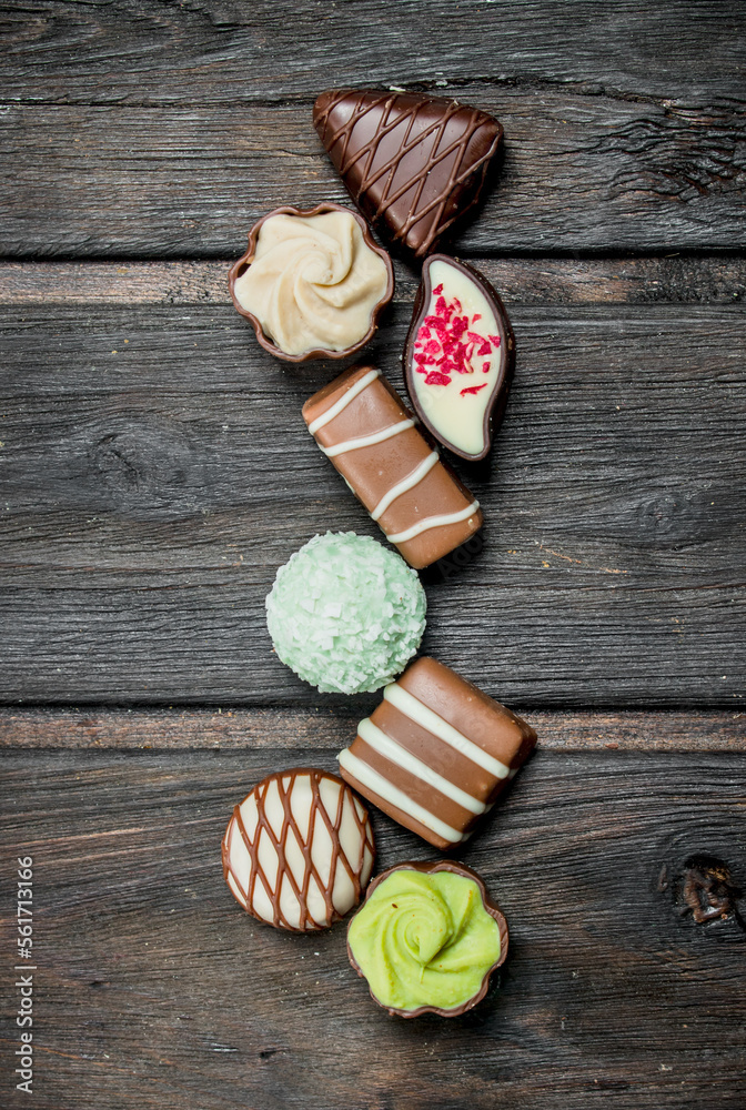 Fototapeta premium Chocolate sweets with nuts and various fillings.