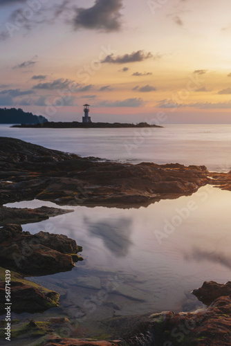 reflection of water on the rocks on the beach, lighthouse on the coast evening sunset kaolak phuket thailand