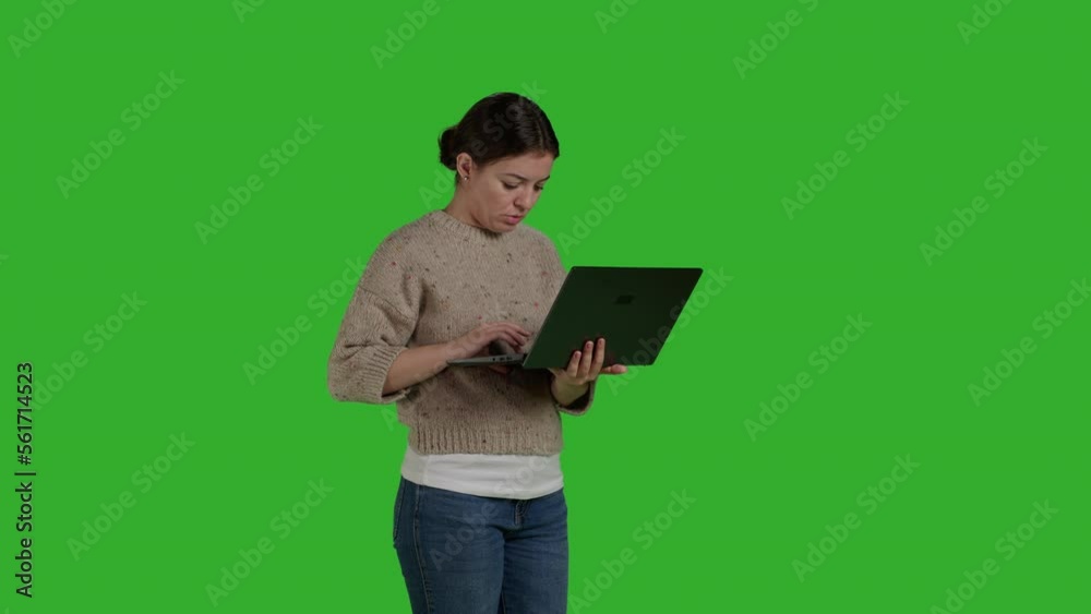 Side view of confident girl scrolling through internet on laptop, working with portable pc over isolated green screen backdrop. Modern woman using wireless computer and online social media app. Side view of confident girl scrolling through internet on laptop, working with portable pc over isolated green screen backdrop. Modern woman using wireless computer and online social media app.