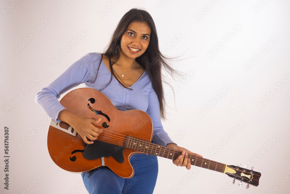 Woman playing guitar against white background Woman playing guitar against white background