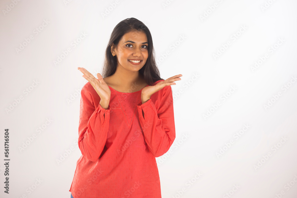Portrait of a smiling woman gesturing against white background Portrait of a smiling woman gesturing against white background