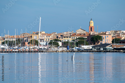 Saint Tropez view from far away with palm trees water and blue sky