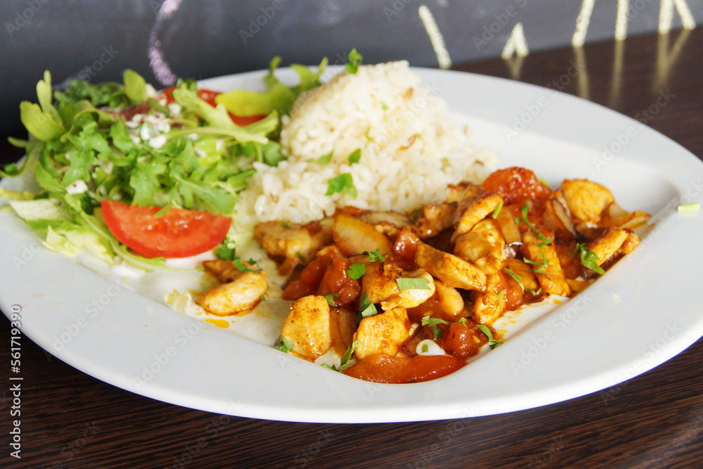 Lunch combi chicken dish with rice and salad. Lunch combi chicken dish with rice and salad.