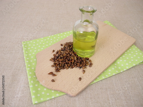 Healthy grape seed oil from grapeseeds in a glass bottle