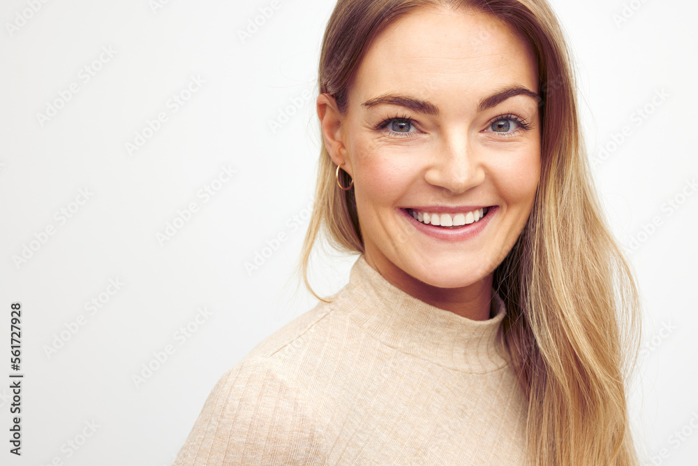Close-up portrait of a young happy woman smiling on white background Close-up portrait of a young happy woman smiling on white background