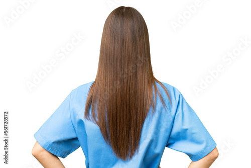 Young nurse caucasian woman over isolated background in back position