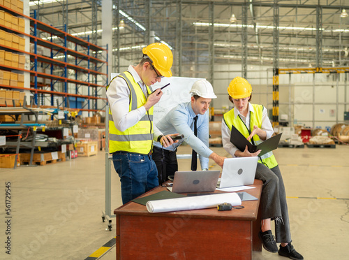 Teamwork of workers working in large warehouse retail store industry.Rack of stock storage. Interior of cargo in ecommerce and logistic concept. Depot. People lifestyle. Shipment service for container