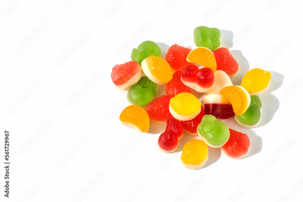Multicolored jelly fruit candies on a white isolated background.