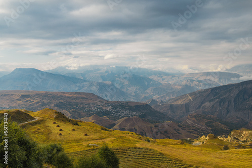 Snow-capped mountains and autumn fields. Beautiful mountain landscape in winter. Panoramic view  Dagestan  Russia.