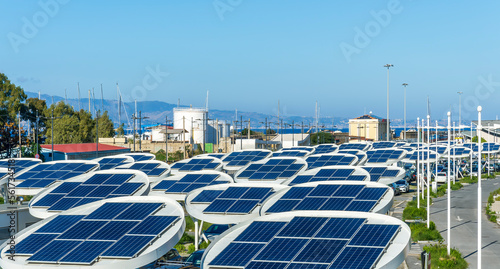 solar power plant with big antennas on a parking for charging electrocars, car energy of future photo