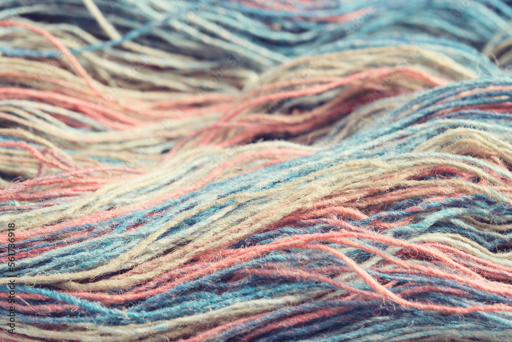 Threads from natural organic sheep wool. Close-up, macro. Unwound skein of multicolor rainbow knitting yarn. Threads from natural organic sheep wool. Close-up, macro. Unwound skein of multicolor rainbow knitting yarn.