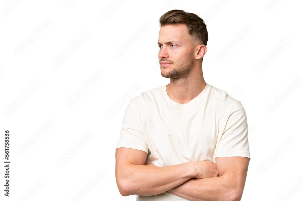Young blonde caucasian man over isolated background looking to the side Young blonde caucasian man over isolated background looking to the side