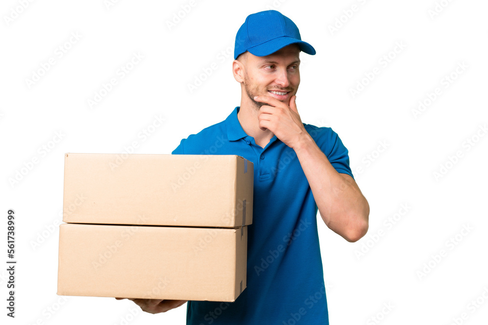 Delivery caucasian man over isolated background looking to the side and smiling Delivery caucasian man over isolated background looking to the side and smiling