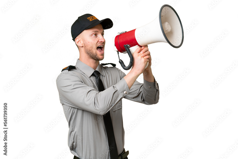 Young security caucasian man over isolated background shouting through a megaphone Young security caucasian man over isolated background shouting through a megaphone