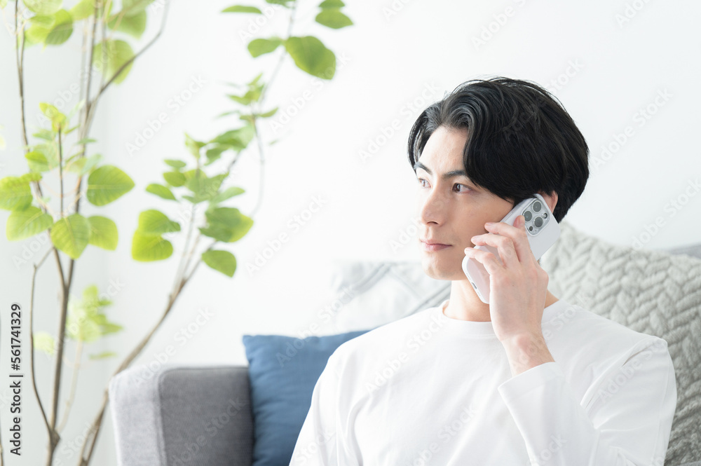 Asian male inquiring by phone, copy space available, straight face, profile Asian male inquiring by phone, copy space available, straight face, profile