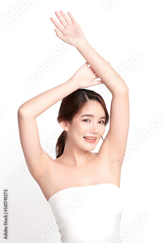 Beautiful Young Asian woman lifting hands up to show off clean and hygienic armpits or underarms on white background, Smooth armpit cleanliness and protection concept © kitthanes