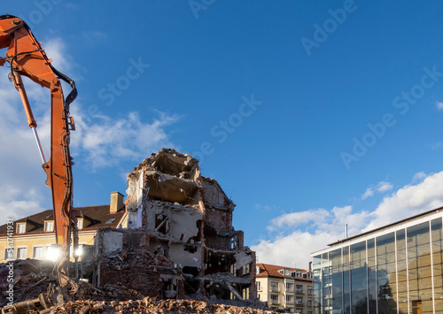 Germany, Bavaria, Munich, Construction vehicle demolishing building photo