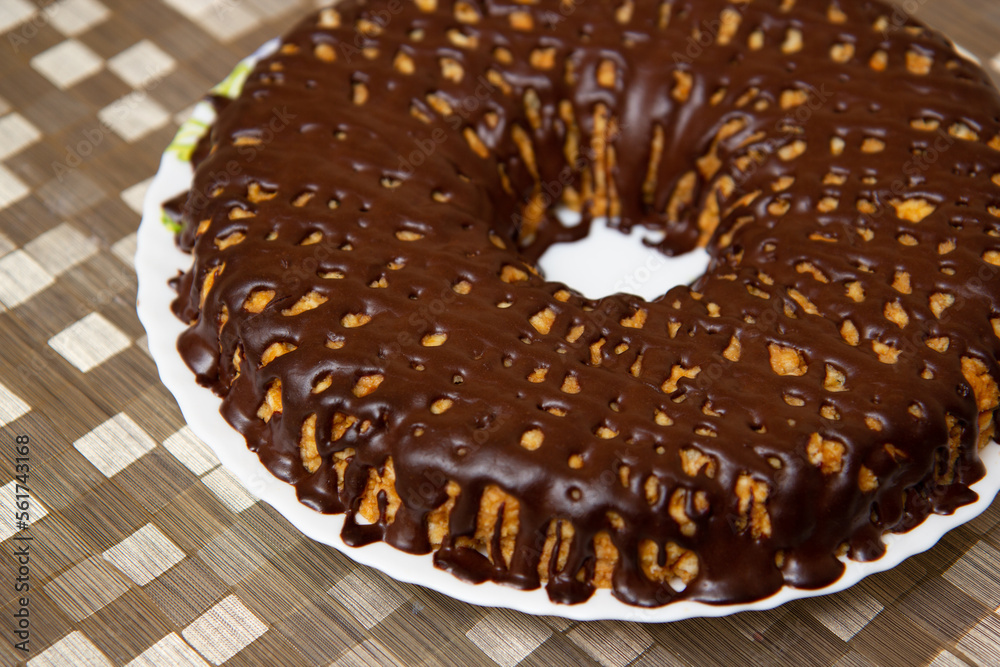 chocolate donut on a platter on a golden tablecloth chocolate donut on a platter on a golden tablecloth