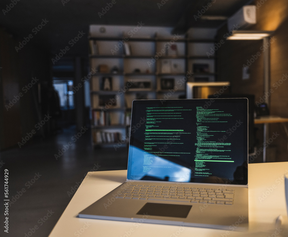 Laptop with data on screen kept at desk in office Laptop with data on screen kept at desk in office
