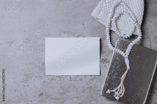 Composition of muslim prayer equipment with blank space for text on white paper isolated on gray background. 