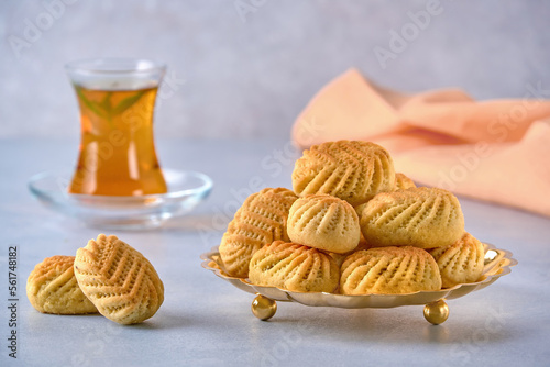 Traditional arabic semolina maamoul or mamoul cookies with dates , walnuts and pistachio nuts . Closeup