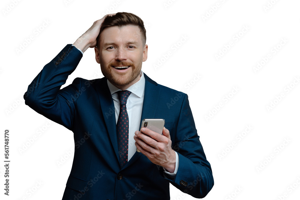 Horizontal shot of handsome bearded businessman keeps hand on head smiles gladfully holds smartphone uses platform for banking dressed formally isolated over grey background. Corporate director Horizontal shot of handsome bearded businessman keeps hand on head smiles gladfully holds smartphone uses platform for banking dressed formally isolated over grey background. Corporate director