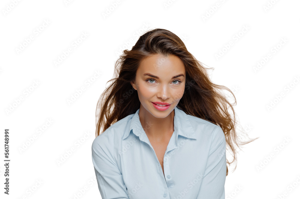 Lovely millennial female looks with satisfied expression at camera, has long hair, dressed in stylish shirt, has natural beauty, models against background, wears makeup, has lively talk Lovely millennial female looks with satisfied expression at camera, has long hair, dressed in stylish shirt, has natural beauty, models against background, wears makeup, has lively talk