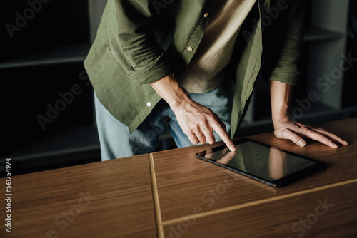 Close up of man working on tablet computer