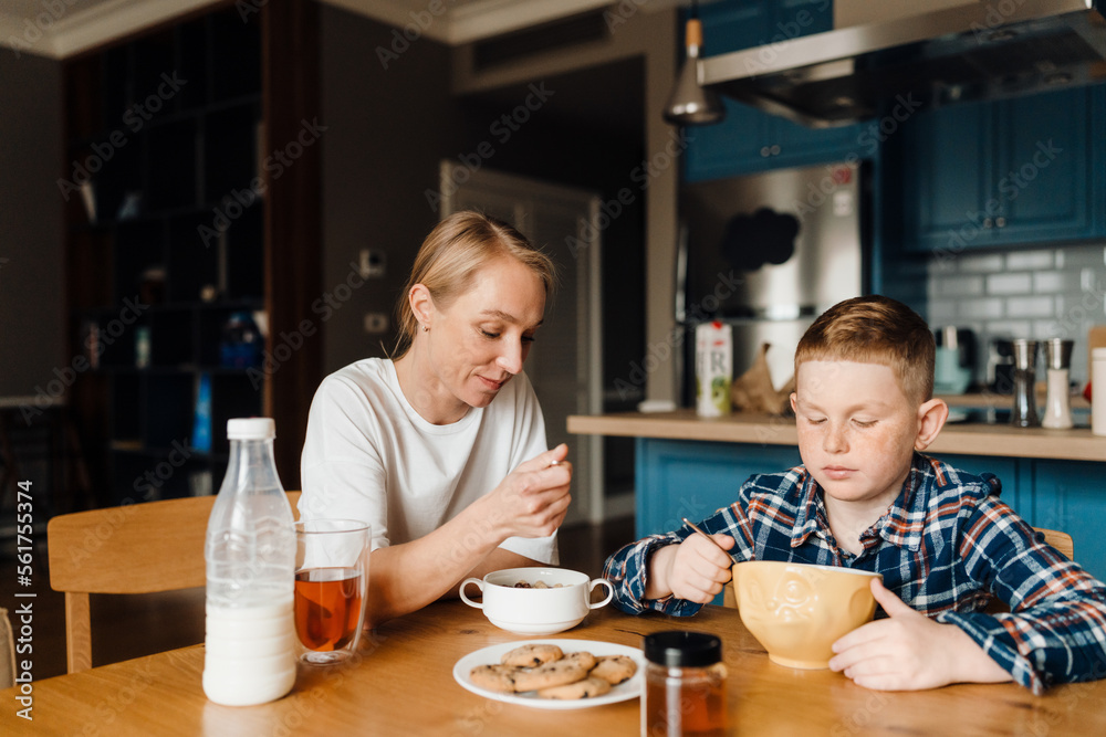 Mom and son eating breakfast at home Mom and son eating breakfast at home