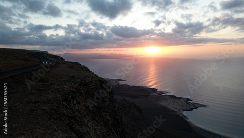 Lanzarote, Canary islands , Spain, Europe - Amazing street car road by the sea during the sunset in Mirador del Rio in north of Lanzarote biosfera reserve - journey and tourist attraction - Graciosa 