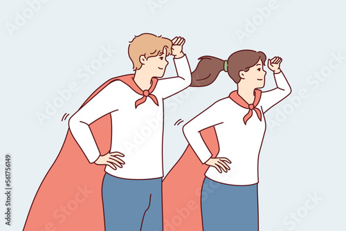 Guy and girl in superhero capes look into distance with their hands to their foreheads. Young man and woman in superhero uniforms for charity or volunteer organizations metaphor. Flat vector image